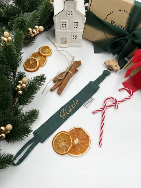 Personalizowana zawieszka do smoczka z haftowanym imieniem i drewnianym klipsem. Praktyczny dodatek do wyprawki niemowlęcej i wyjątkowy prezent dla noworodka.