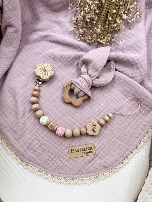 Personalizowana zawieszka do smoczka i szeleszczące uszka z muślinu to wyjątkowy zestaw dla niemowlęcia. Idealny prezent dla noworodka, wykonany z naturalnych materiałów. Idealny prezent na narodziny, baby shower lub chrzciny.
